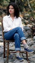 freepik__young-debra-winger-wearing-white-shirt-cuffed-jean__5232.png