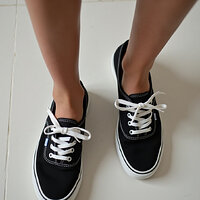 pikaso_texttoimage_photo-of-a-womans-feet-wearing-black-Keds-sneakers-3.jpeg