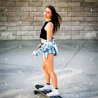 young-woman-riding-a-skateboard-in-a-downtown-urban-area.JPG