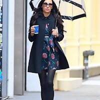34980126-8891435-Under_her_umbrella_During_her_outing_the_former_Bond_girl_comple-a-86_1603939...jpg