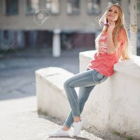 78288573-stylish-happy-blonde-woman-wear-at-jeans-sunglasses-and-t-shirt-posed-at-street-on-su...jpg