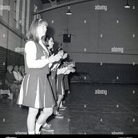 1965-historial-schoolgirls-cheerleaders-inside-a-sports-hall-supporting-their-college-basketba...jpg