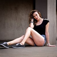 free-photo-of-woman-sitting-by-wall-and-posing.jpeg