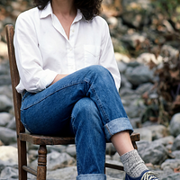freepik__young-debra-winger-wearing-white-shirt-cuffed-jean__5232.png