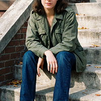 freepik__young-sean-young-wearing-img1-sitting-on-steps-fro__5203.png