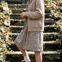 freepik__young-debra-winger-wearing-cardigan-sweater-floral__45112.png